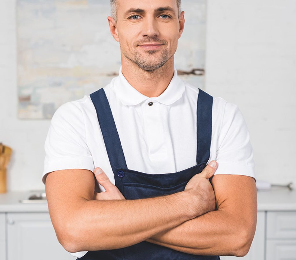 adult-repairman-in-tool-belt-standing-with-crossed-WEJMUQM.jpg
